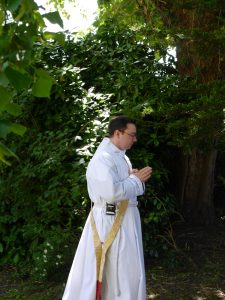 The then Deacon James waits to enter the Cathedral from the garden.