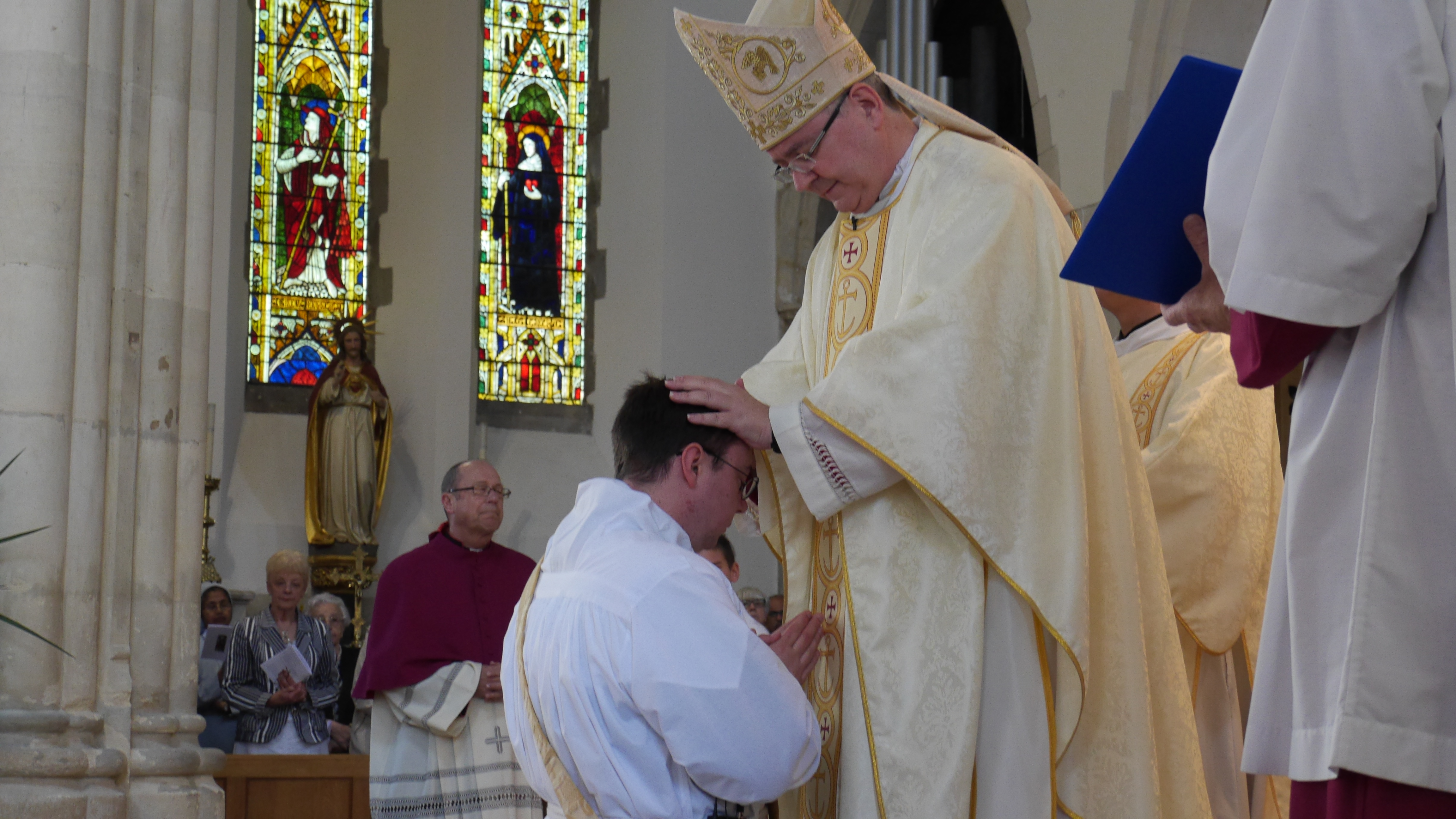 Bishop Mark places his hands on Deacon James head and recites the Prayer of Ordination. At this moment, the bishop confers the Holy Spirit upon him and Deacon James becomes Fr James Barber