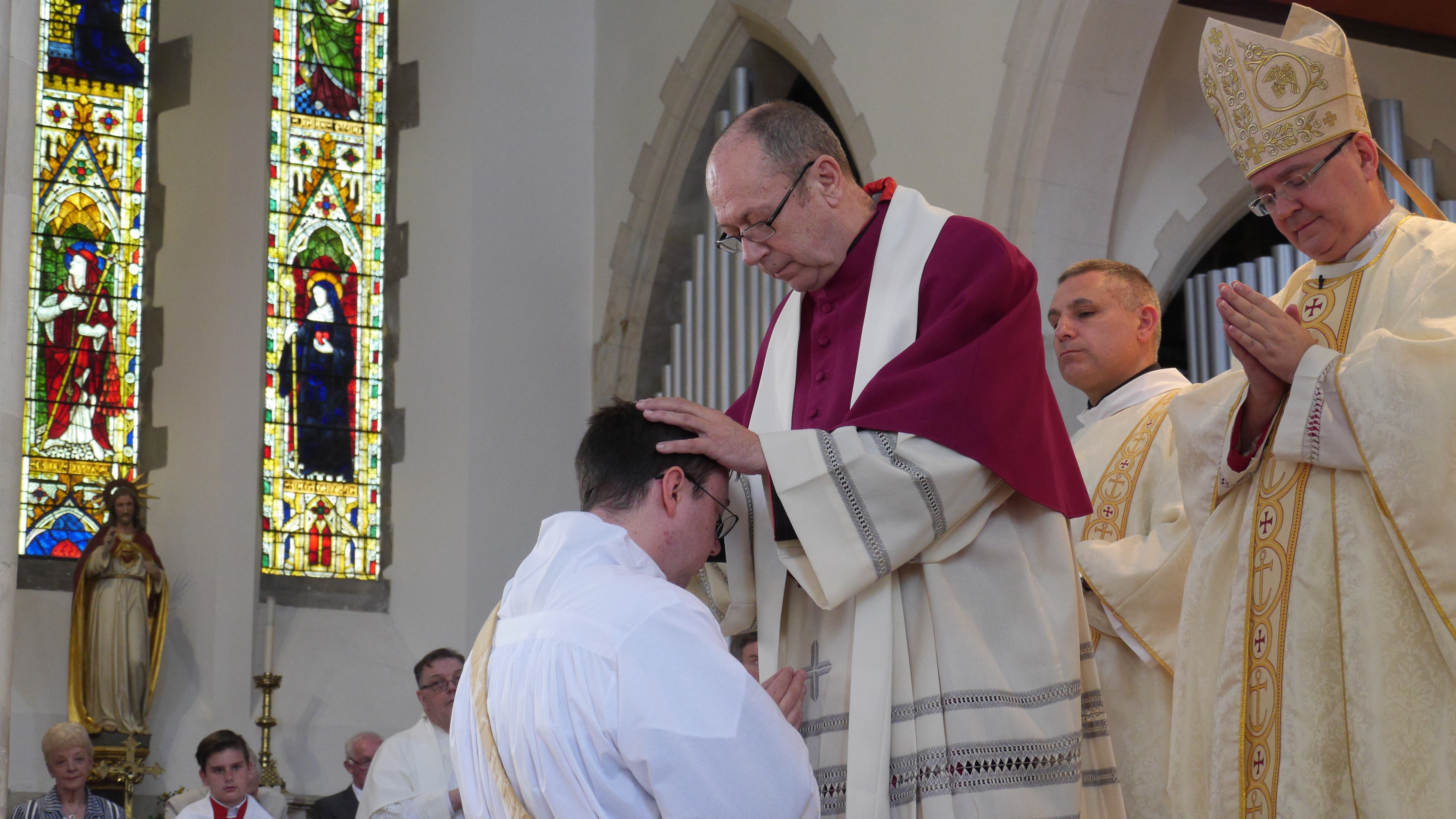 As is tradition all priest present at the Ordination place their hands on Fr James's head.
